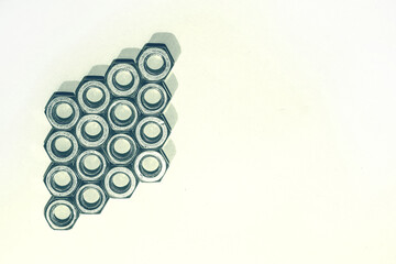 Geometrically folded nuts. Nuts on a white background for design. Hexagon nuts for work