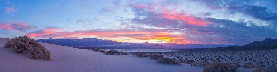 Obraz premium Eureka Dune at sunset is illuminated by a gentle pink light against a backdrop of dramatic clouds, Death Valley National Park, USA