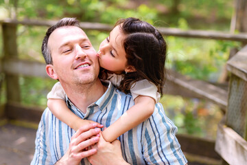Obraz premium Father with his daughter having fun outside in forest