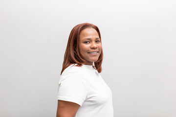 A portrait of a black woman smiling with joy and looking at camera at the dental clinic where she usually takes treatment