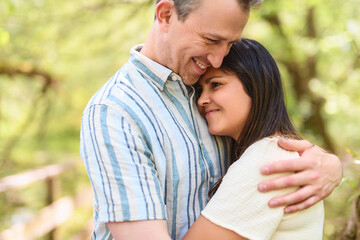 Young Caucasian couple outside in the forest background