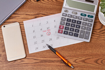 Business accauntant workplace top view flat lay. Calculator with oen and phone on brown wooden desk.