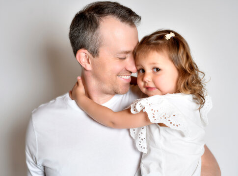 Father with his daughter on studio white background