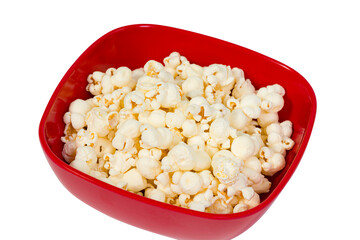 Macro close up of popped popcorn kernels in a red bowl with a shallow depth of field isolated on white