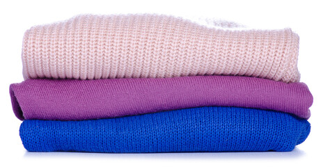 Stack foded sweaters clothes on white background isolation