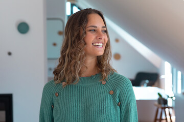 Caucasian beautiful young woman smiling in the living room at home