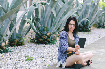 Portrait of young happy business woman, student relaxing, working in city in botanical garden. Using laptop. Selfie. Technology. Social media. Video call. Summer vacation