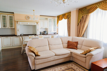 corner sofa in the interior of a large and spacious kitchen-living room.
