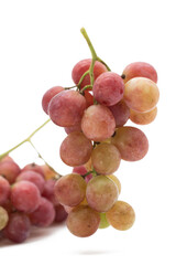 Bunch of red grapes with water drops. Isolated on white background.