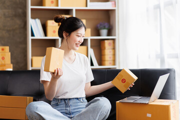 Business digital online SME small business a new startup in the present for an online shop. Happy Young Asian woman have a warehouse used to send a customer Entrepreneur owner SME or freelance concept