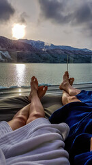 Couple relaxing on the sun beds in Spa, Badehaus Millstaetter See, Austria, by Millstaetter See....