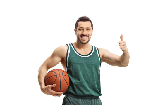 Smiling basketball player holding a ball and showing thumbs up