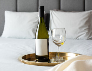 glass of wine on the bed in apartment