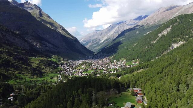 Aerial view of Zermatt, town under famous mountain Matterhorn, summer - landscapes of Swiss Alps from above, Switzerland, Europe. Drone footage 4K.