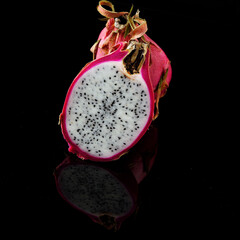 
Pitaya and Dragon Fruit on a black background, cut into two parts.
