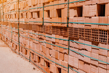 Pallets with freshly made racks of bricks at a construction site or near an industrial plant. Storage of building materials at the warehouse