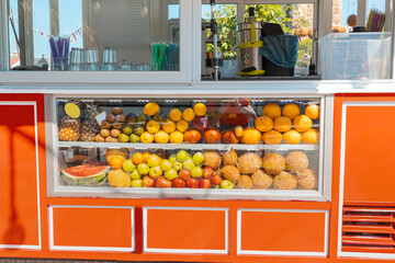 Juice and fruit shop stall at the city street. Retail small business and healthy beverage