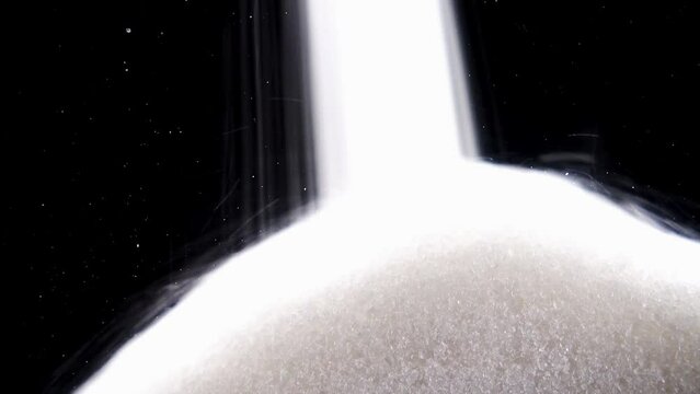 Sea Salt Pours On A Black Background.