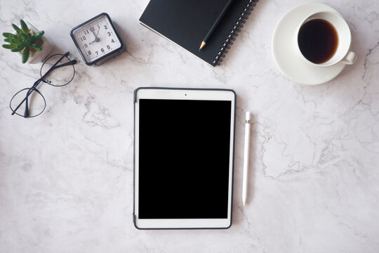 Mockup picture of business woman’s hands using tablet with white blank screen in modern place