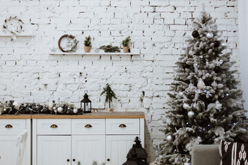 bright kitchen interior with white brick wall. decorated Christmas tree