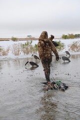 A waterfowl hunter with a string of decoys 