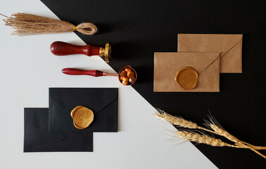 Wax seal on black and craft envelopes. Twine, wax seal, spoon with sealing wax, envelopes, ears of...