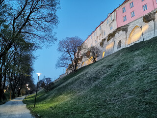 Houses of white and pink color on the medieval defensive wall of the city in the early spring...