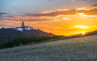 Pannonhalma Archabbey with wheat field on sunset time