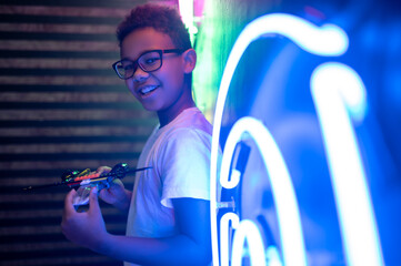Smiling happy adolescent with a toy helicopter in hands