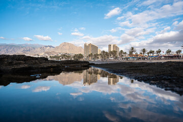 cityscape reflected in las americas beach, tenerife
