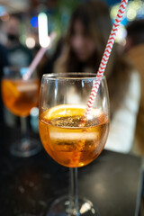 glass of apperol spritz with straw