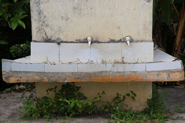 Two Plastic water taps at outdoor washbasin