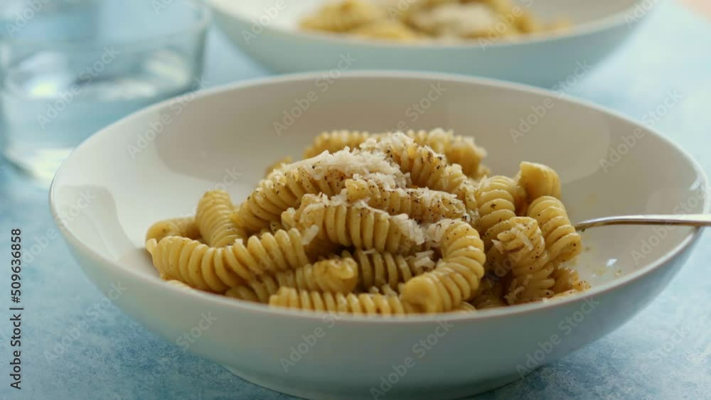 Sticker plate of pasta with pesto genovese, with fresh basil, olive oil, garlic and pine nuts