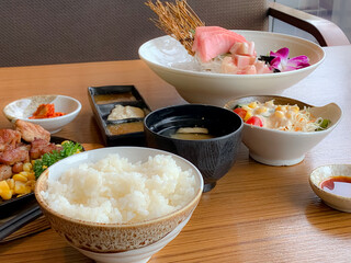 Various menus, sushi, sashimi, nigiri, pan fried pork and miso soup. Sashimi, chutoro sashimi, Japanese food chopsticks and wasabi on the black table, Japanese food style. blurs focus.