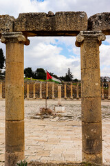  Jerash, Jordan - Jordanian flag in historical Jerash city (Grassa) Roman and Greek city