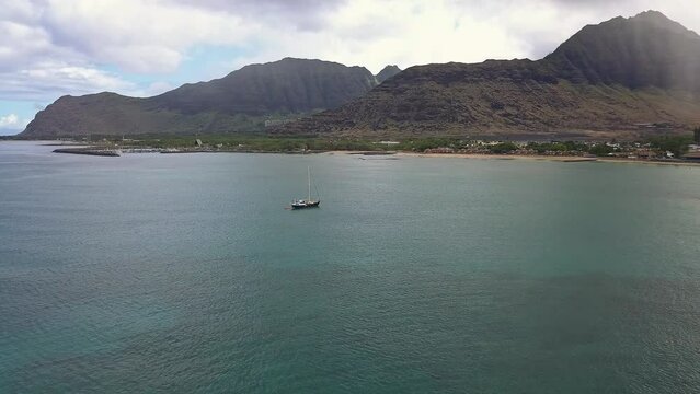 Aerial view of lone sailboat in Pokai bay Waianae Oahu on a calm day