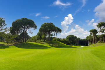 Fototapeta na wymiar Golf course panorama with beautiful sky. Landscape view of golf course in Turkey Belek