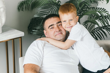 Fototapeta premium Father and son at home on the couch. 