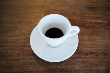 Empty white coffee mug on isolated wooden table background
