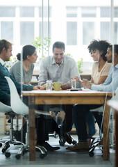Having a successful business meeting. Real life businesspeople shot on location. Since these locations are the real thing, and not shot in an 'office studio', high ISO levels are sometimes needed to