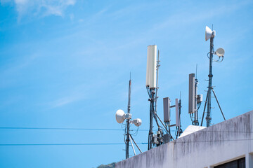 Telecommunication base station network repeater antenna on top of the building. 4G & 5G antenna