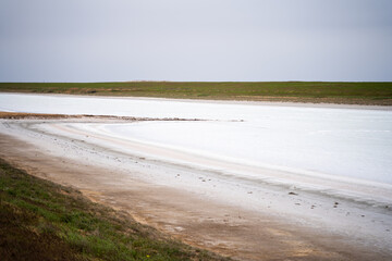 salt marsh in the desert, dry salt lake and salt at the bottom of the lake white and salty