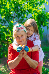 Fototapeta premium Child and grandmother hand drawn flag of Ukraine. Selective focus.
