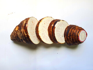 Taro slices and cube was cuted for cooking new dishes  on white and wood background.
