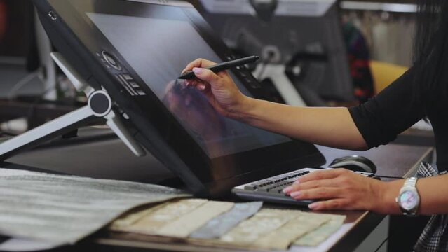 Drawing on a graphics tablet. The designer draws on a graphics tablet. Working with interactive pen display. closeup. Wallpaper production.