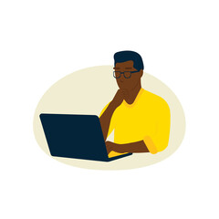 a dark-skinned man is sitting at a laptop