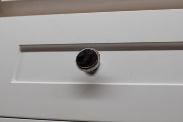 White kitchen built with shaker style cabinets shows cabinet details and brushed hardware knobs