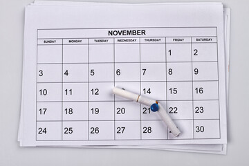 No smoking day in 21 of november. White month calendar. Broken cigarette on the push pin.