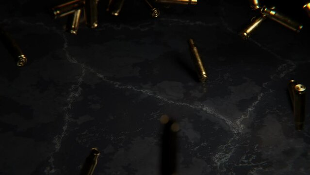Falling bullet casings hitting stone floor.