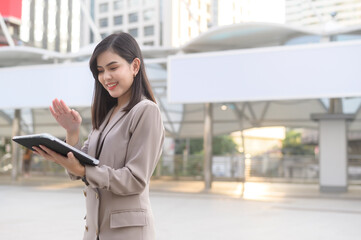 A young beautiful businesswoman is using tablet in Modern city , business technology , city lifestyle concept